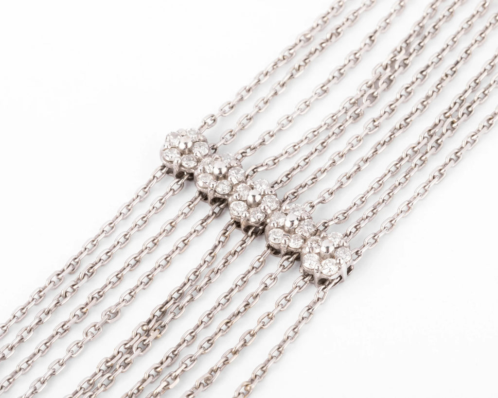 Grey gold and diamond bracelet on a filed cable chain alternating with 4 floral motifs