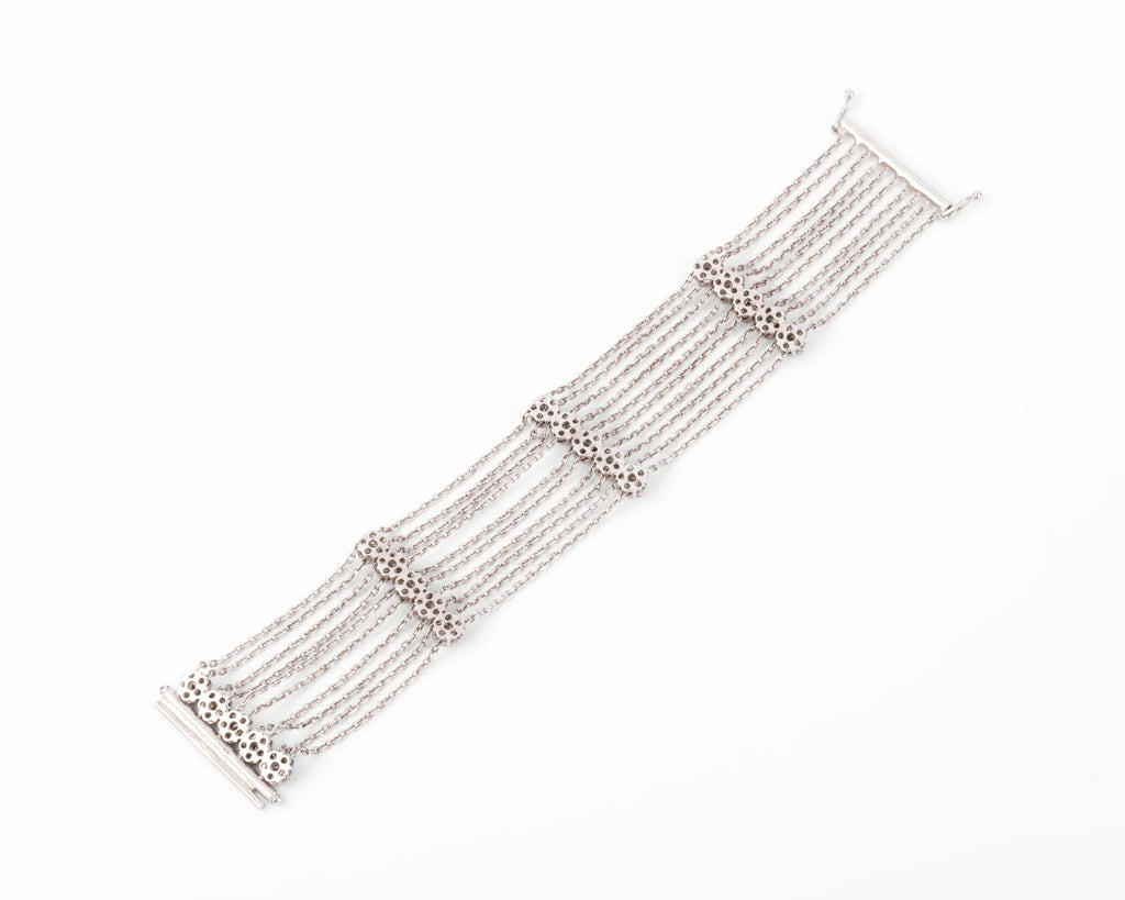 Grey gold and diamond bracelet on a filed cable chain alternating with 4 floral motifs